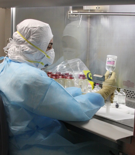 A technician works under a biohazard hood to aseptically admix chemotherapy in a cleanroom. Baxter CIVA helps hospitals increase the IV admixing capacity of their in-house pharmacy. Baxter’s new CIVA will double its number of cleanrooms available to support customised requirements for hazardous and non-hazardous IV admixing. (CNW Group/Baxter Corporation)