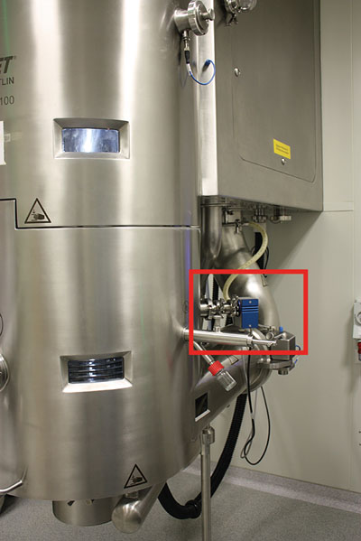 Figure 3: NIR instrument attached to a fluid-bed coater: deposits on the NIR probe itself can occur during the coating process but are mathematically corrected for during data acquisition; therefore, the progress of the coating process can be monitored and actively controlled in real-time