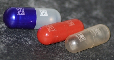 A 2mm x 2mm matrix code printed onto the surface of drug capsules