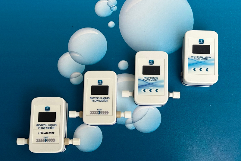 Non-invasive real-time liquid flowmeters
